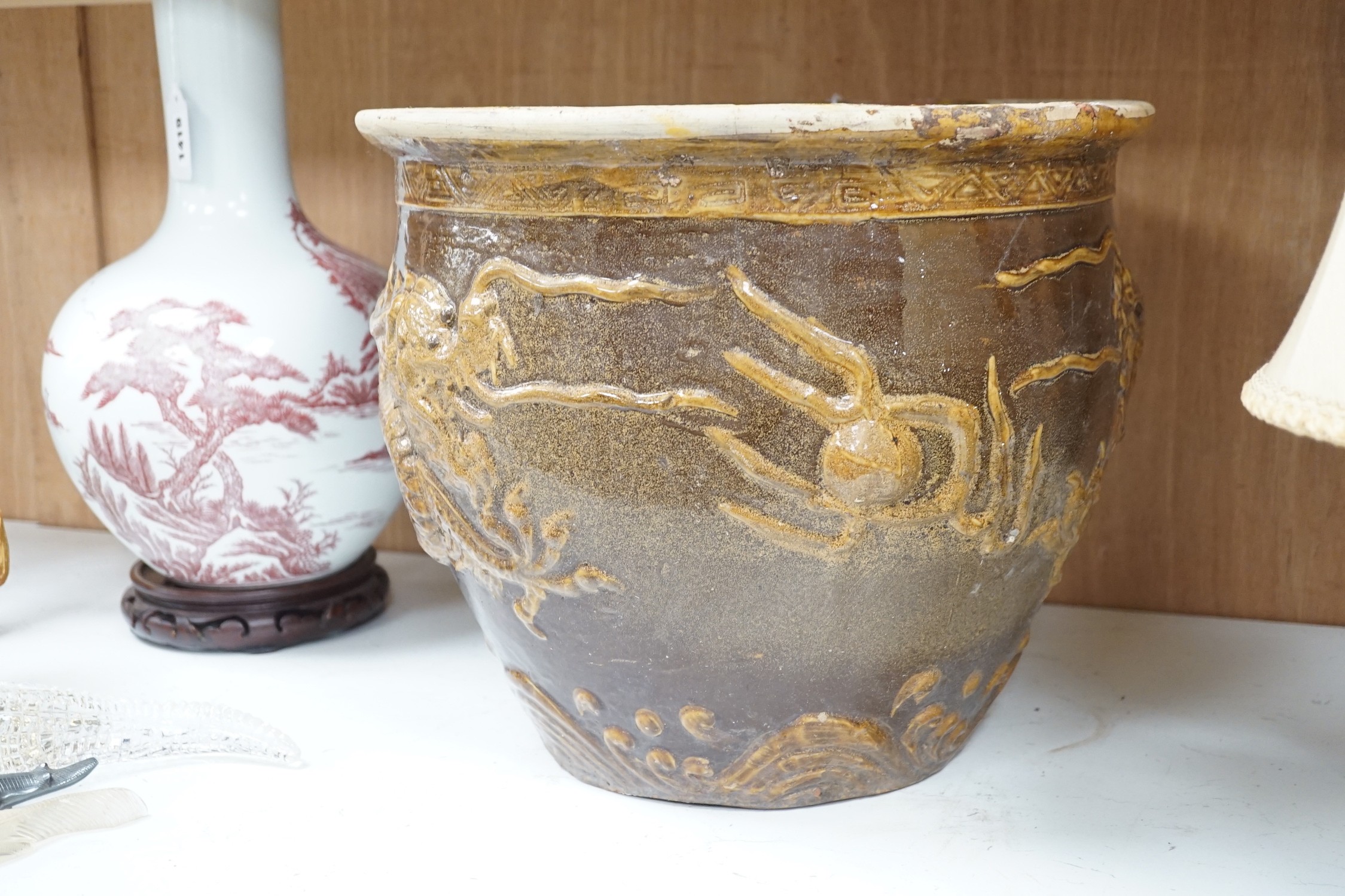 A Chinese Brown and treacle glazed dragon planter. 32cm tall